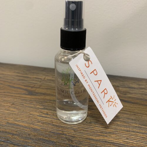 A vibrant bottle of Spark essential oil spray, featuring a refreshing blend of scents to uplift your senses.