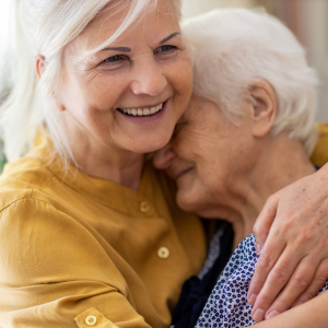 Elderly person is embraced with a hug